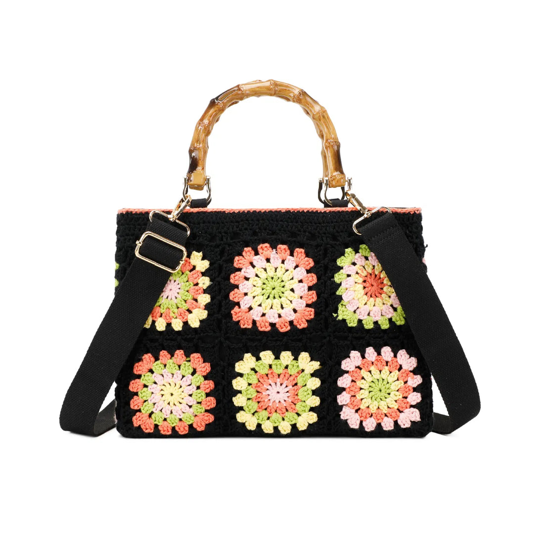 Black crochet grab bags with bamboo handles and gold tone metal hardware.