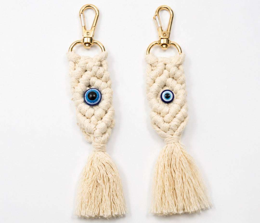 Cream macramé Blue Eye Tassel Keyring with gold clasp and blue eye charm for handbags and keys.