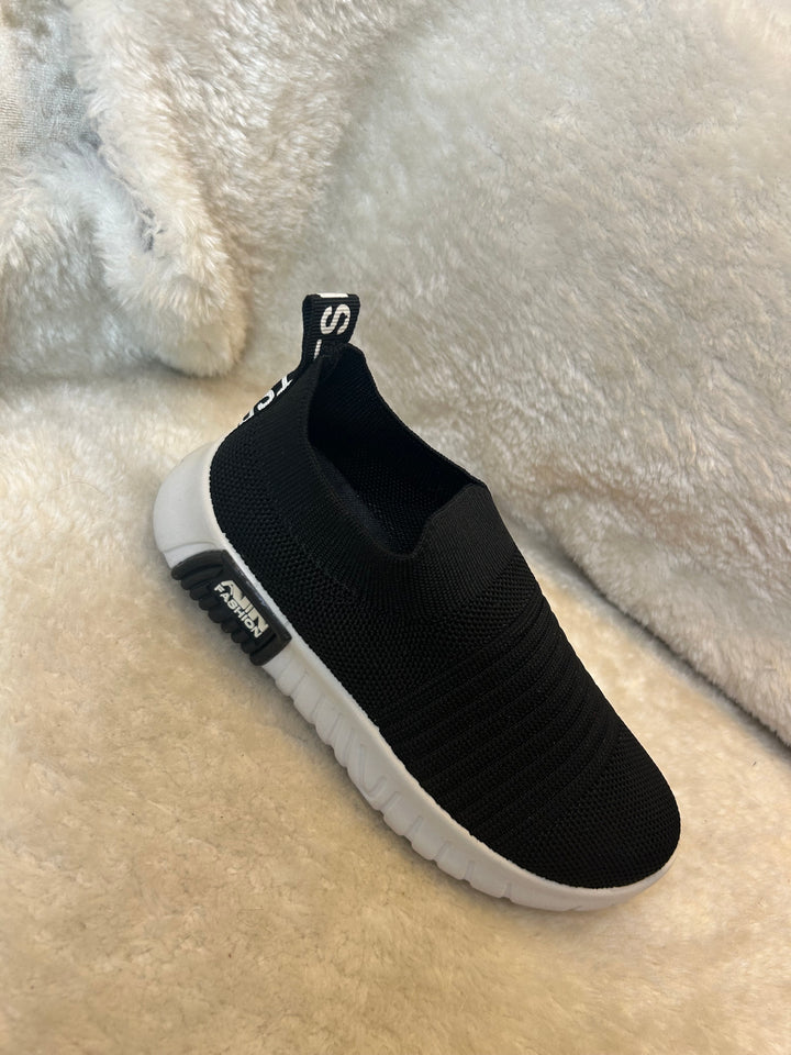 Children’s black slip on trainers with white soles 
