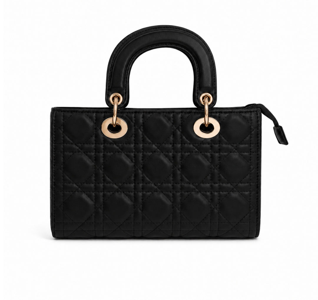 A black quilted top-handle handbag with gold-tone hardware, shown against a plain white background.