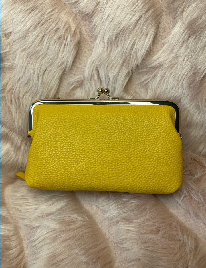 A yellow large clutch purse with silver detailing 