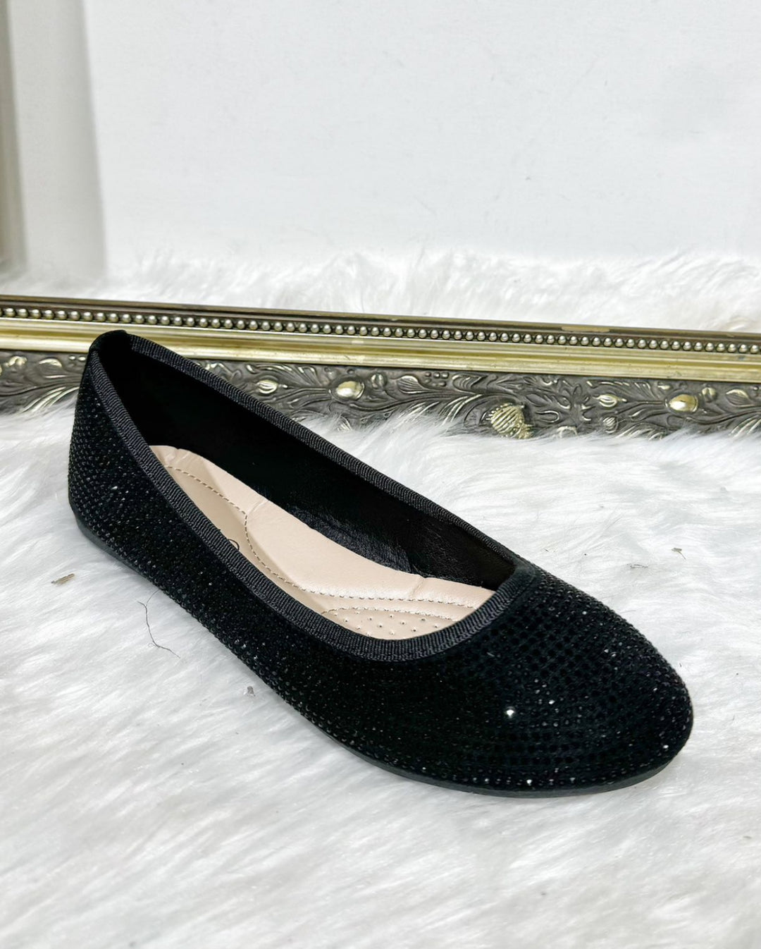 Black sparkly flat shoe with crystal embellishments and cushioned in.