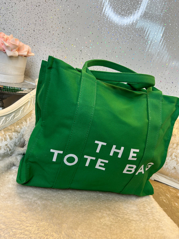 Green canvas style tote bag with &