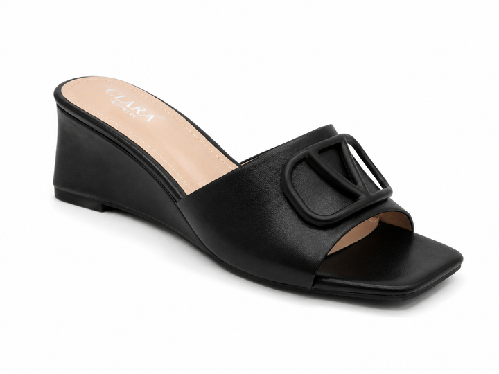 Black wedge mule heels with oversized buckle detail