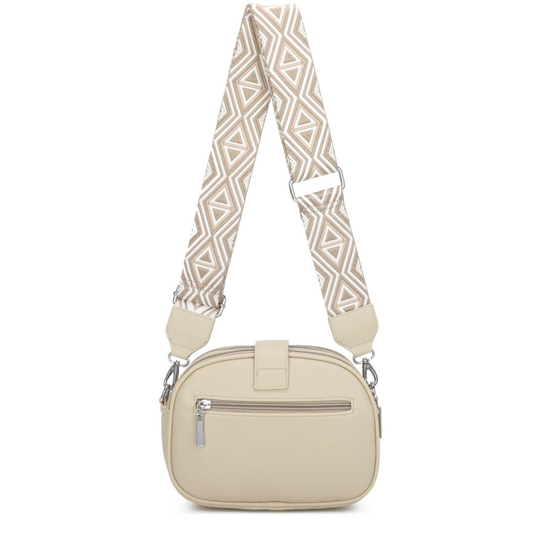 Beige handbag with a patterned strap