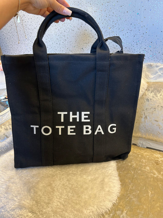 Large black  tote bag with 'THE TOTE BAG' text in white 