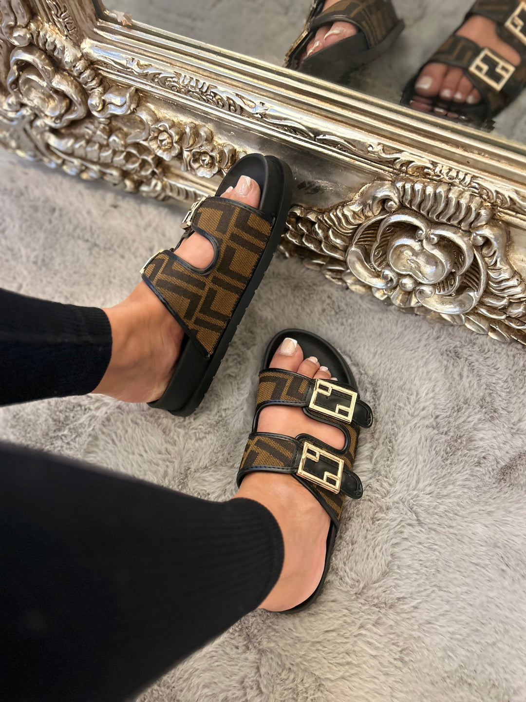 Brown and black patterned sliders with gold buckle detail