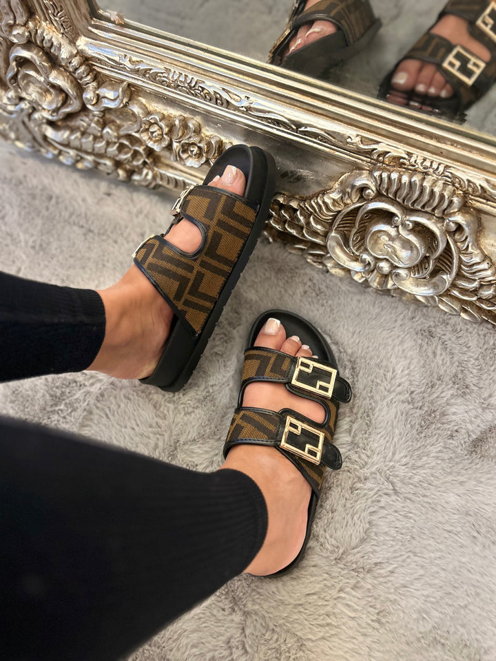 Brown and black patterned sliders with gold buckle detail