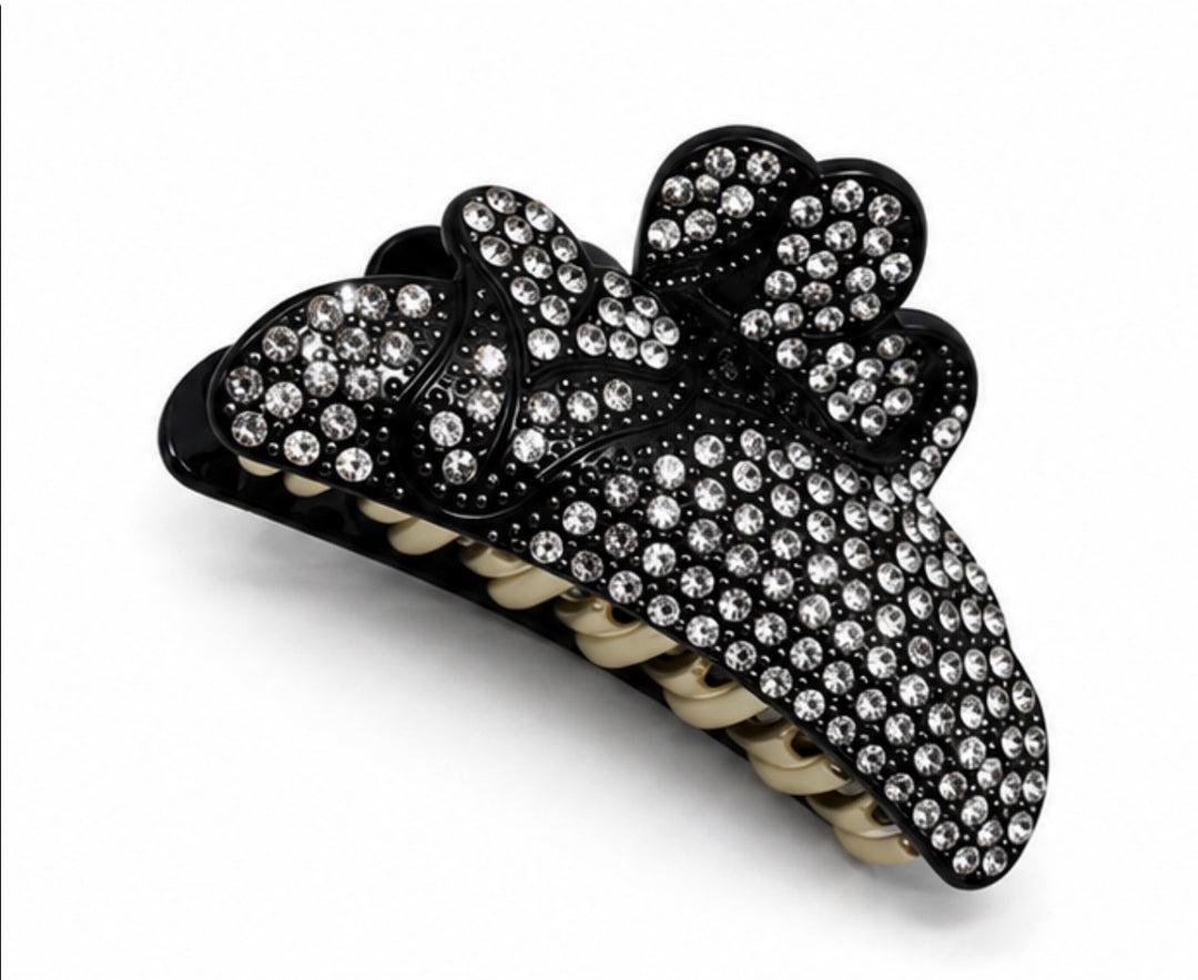Black bow-shaped hair claw clip decorated with sparkling clear diamanté crystals