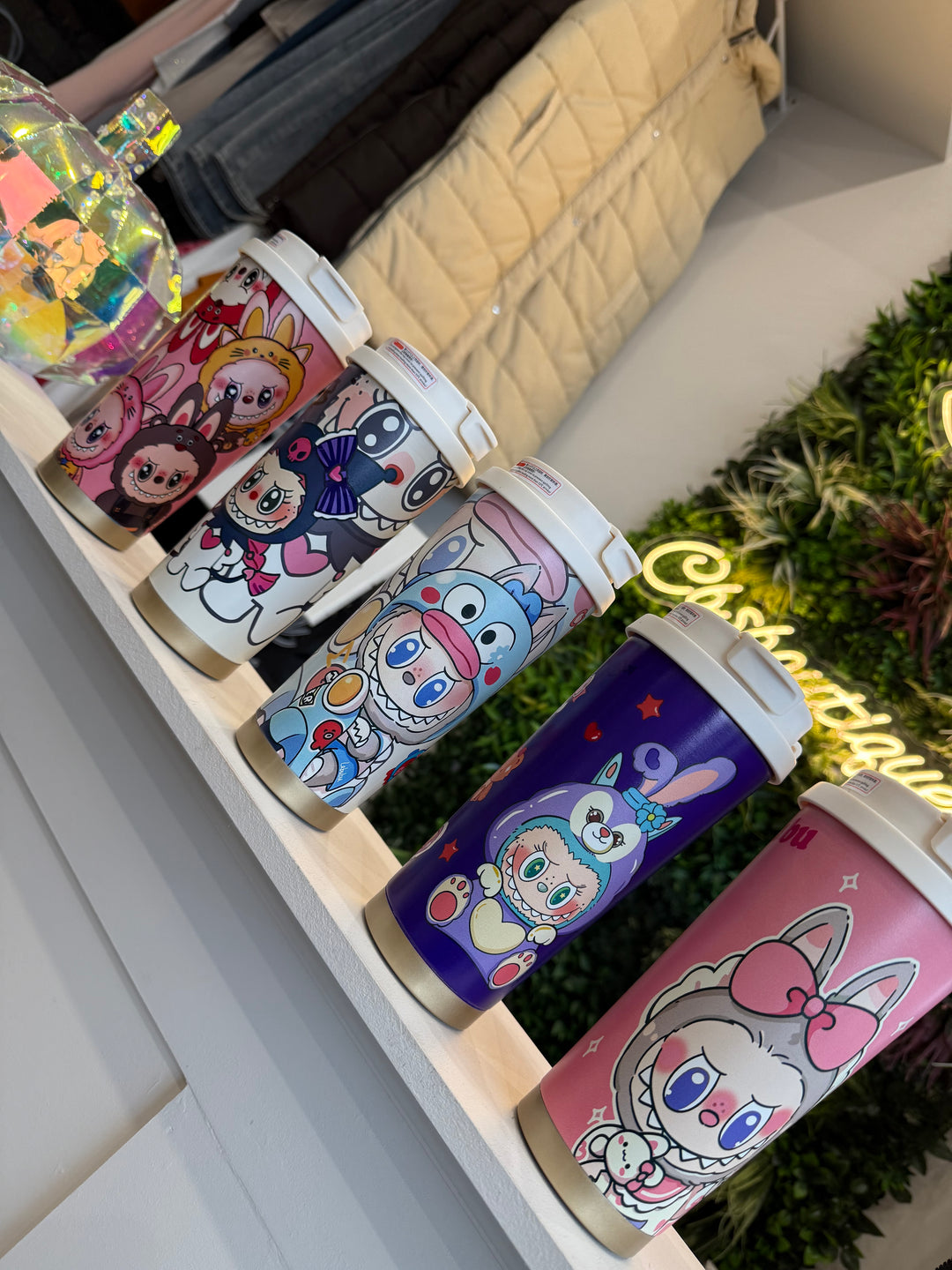 Set of colorful tumblers with cartoon character designs