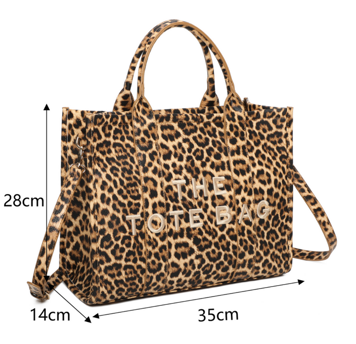A leopard animal print tote bag with double grab straps and gold tone metal hardware.