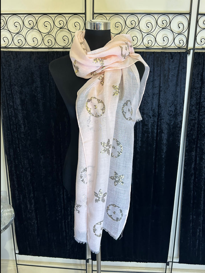 Thin lightweight scarf with flower print design, ideal for spring and summer wear.