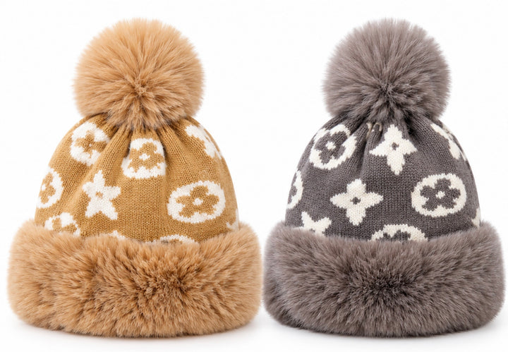 Luxury knitted winter bobble hats in camel beige and grey with cream monogram-style pattern, oversized fluffy pom poms, thick faux fur trims and soft fleece lining.