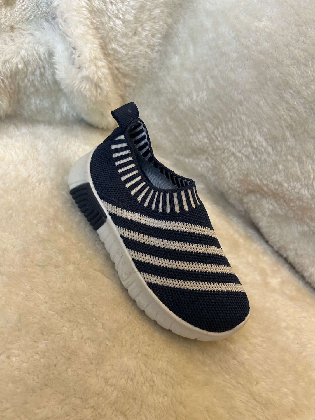 Children’s navy and white slip on trainers with white soles 