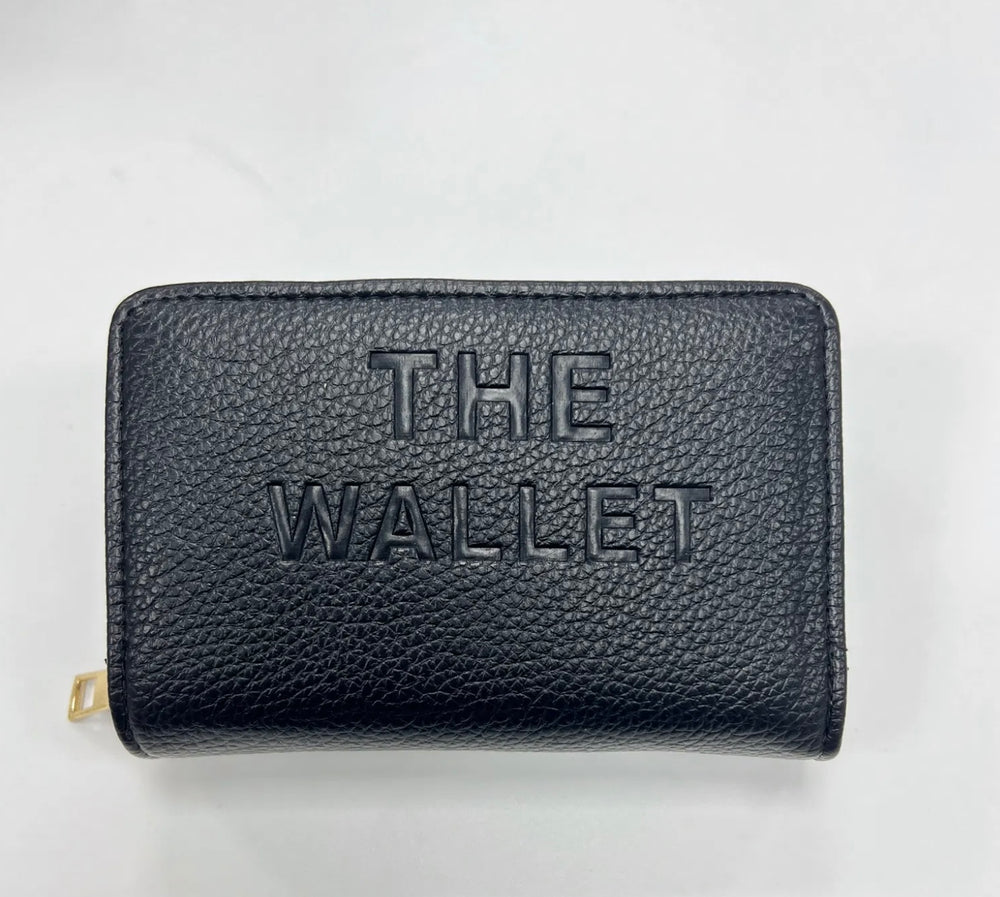 Black purse with gold hardware and “the wallet” embossed on the front
