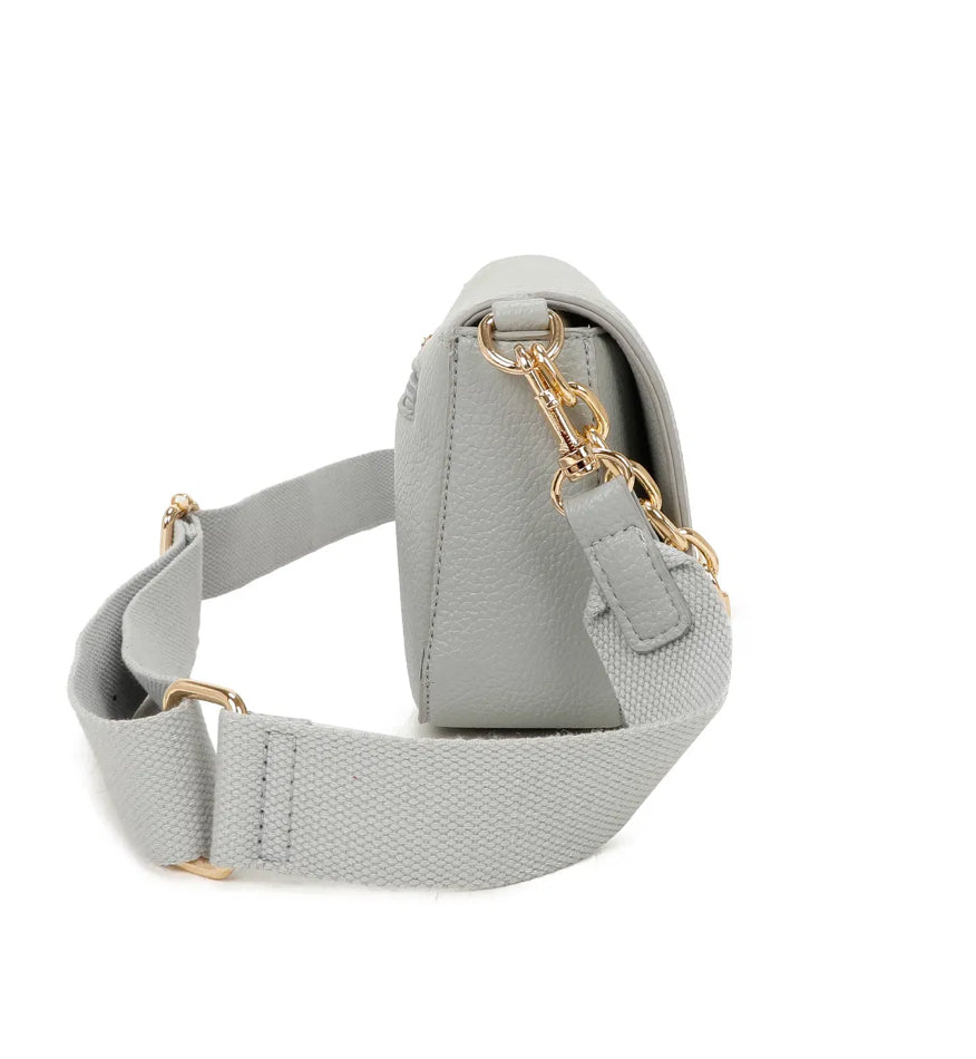 The side of grey handbag with gold chain detail and adjustable strap 