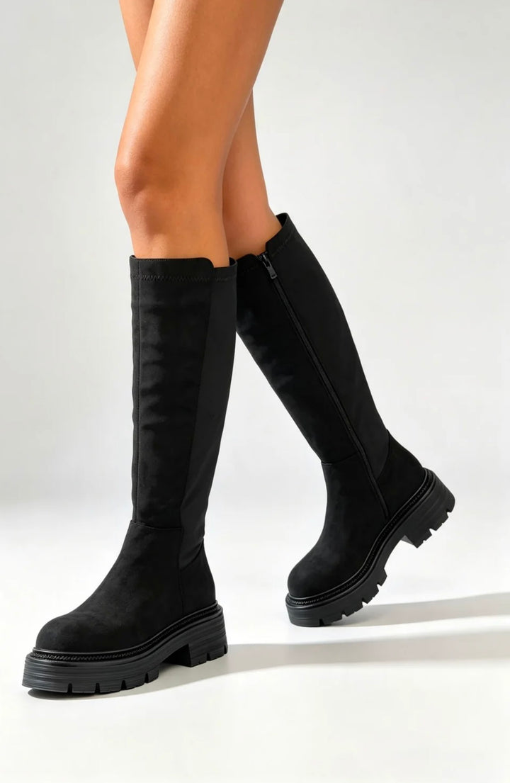 Black faux suede knee high boots with chunky sole on model