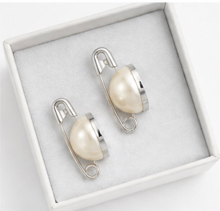 Silver safety pin style stud earrings with ivory faux pearl detail