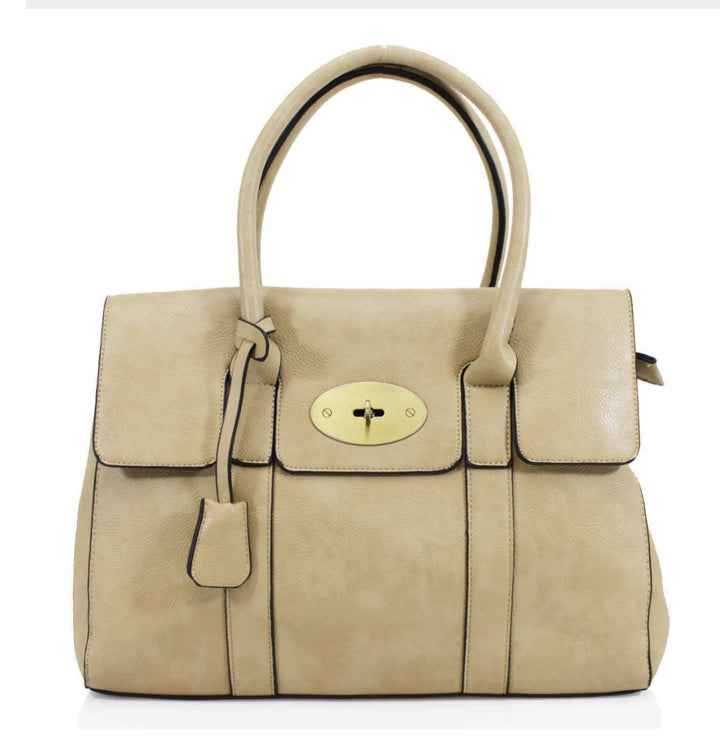 A classic beige handbag with elegant gold detailing, featuring a flap with twist metal lock closure, twin shoulder straps, and golden tone metal hardware.