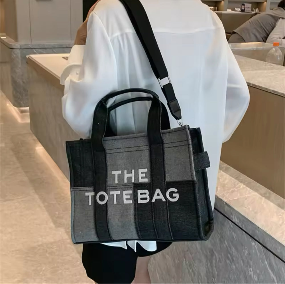 black denim patch work tote bag with bold white ‘The Tote Bag’ text