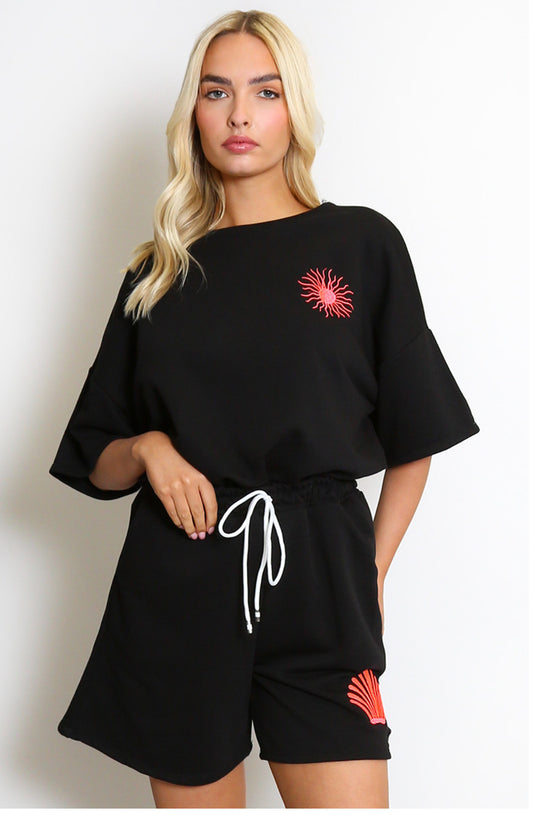 a black outfit with pink sun designs