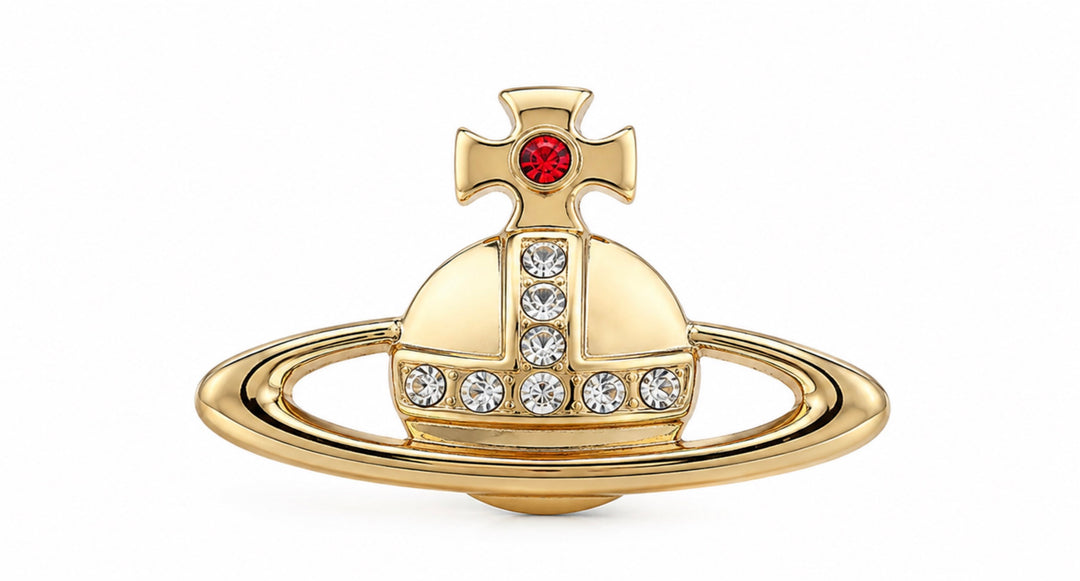 Gold tone orb brooch with clear crystal detailing and red gem