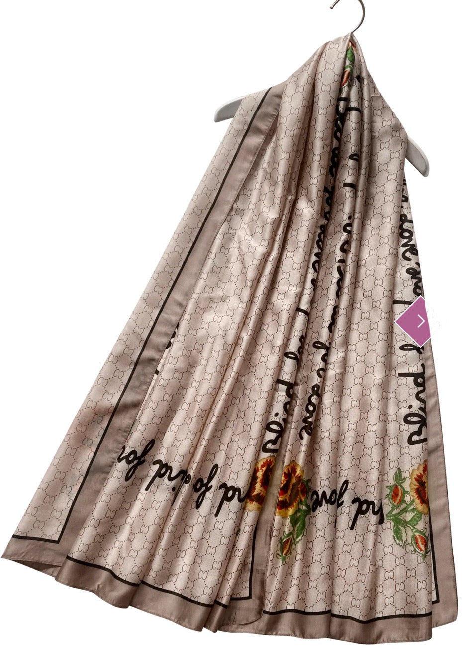 A beige scarf with a geometric pattern and a multicoloured floral emblem.
