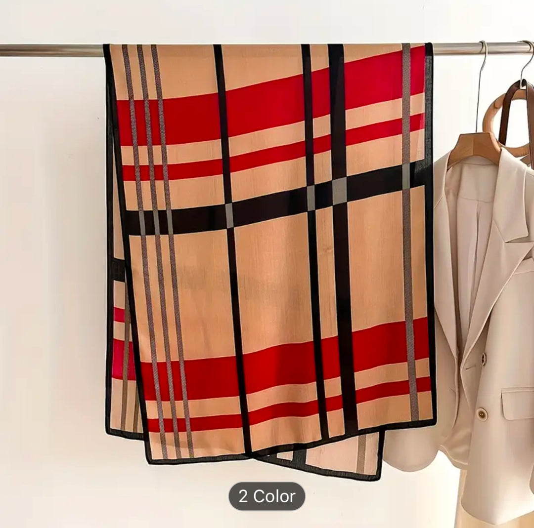 A beige scarf with red and black checked detailed pattern