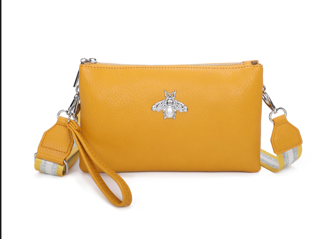 Yellow clutch bag with a decorative bee emblem 