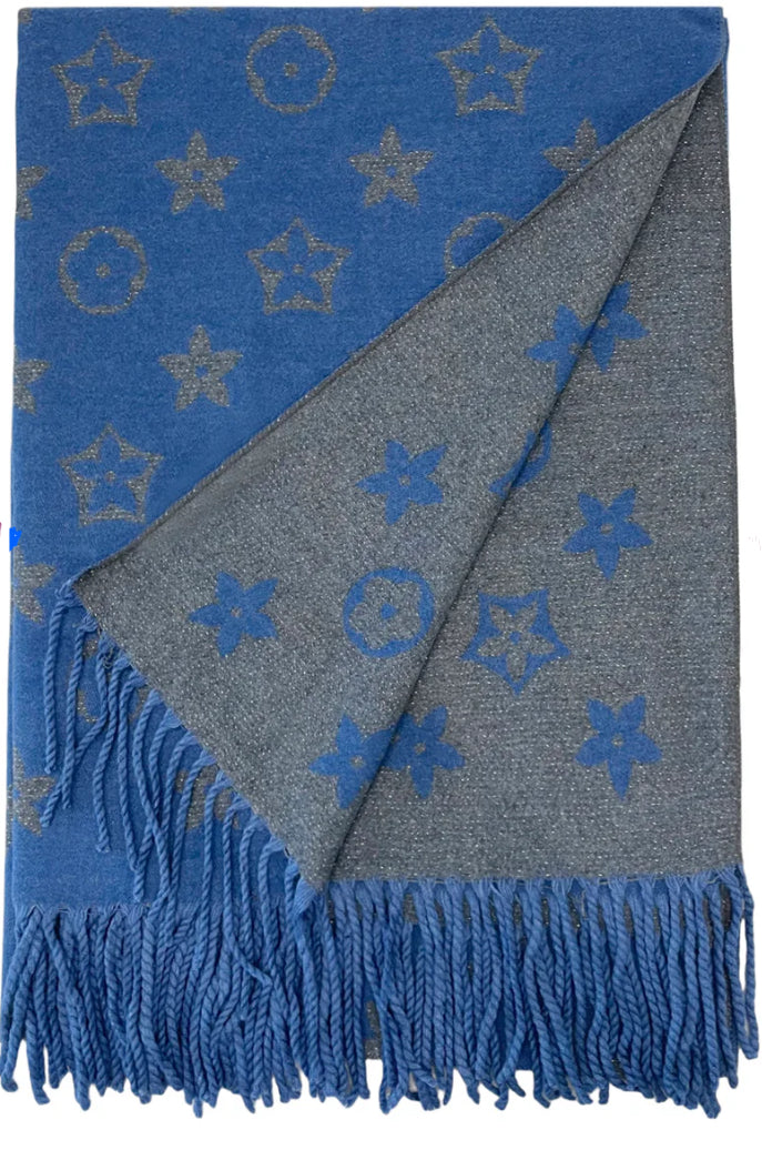 A blue scarf with sparkly metallic thread floral patterns, draped elegantly with a focus on the sparkly details.
