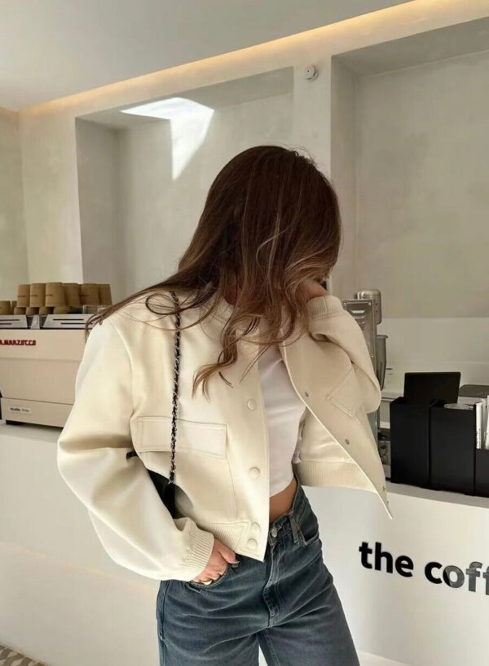 Beige cropped bomber jacket styled with jeans, casual everyday outfit