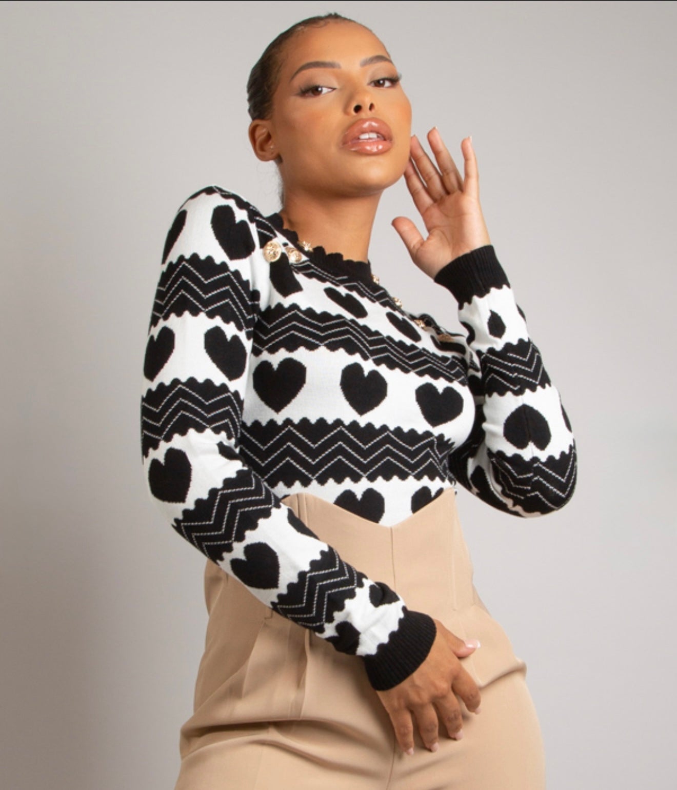 Woman wearing a black and white patterned sweater