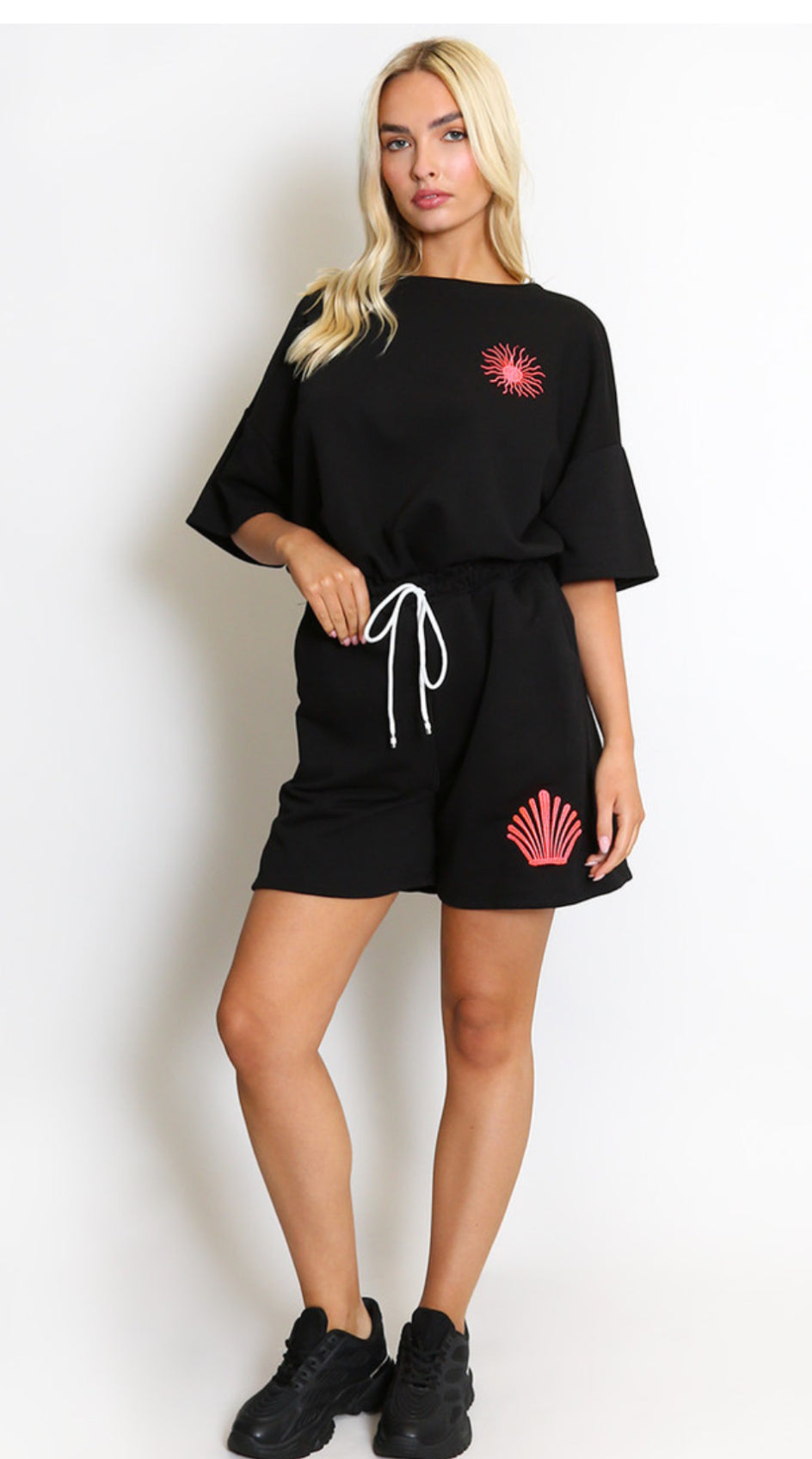 a black outfit with red sun designs