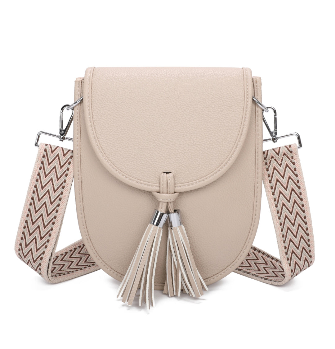 Beige handbag with a decorative strap and tassel 