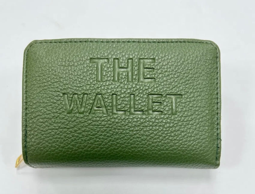 Green purse with gold hardware and “the wallet” embossed on the front