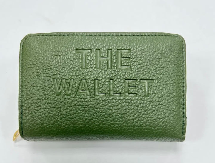 Green purse with gold hardware and “the wallet” embossed on the front