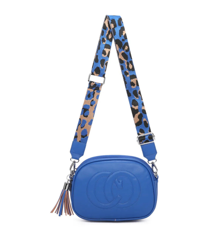 A animal patterned strap cross body bag with a detachable and adjustable strap, featuring multiple zipped compartments and golden tone metal hardware.
