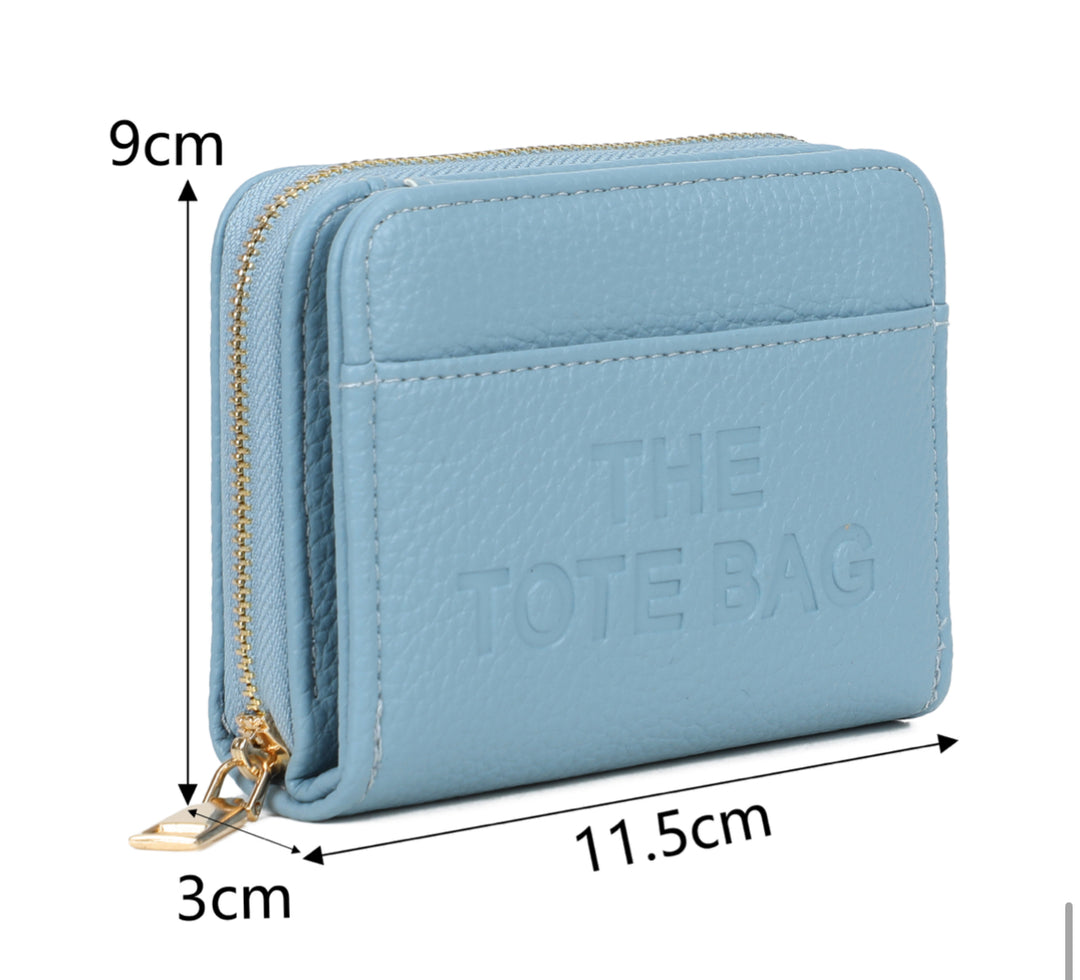 Blue wallet purse  with 'The Tote Bag' and a gold detail zip 