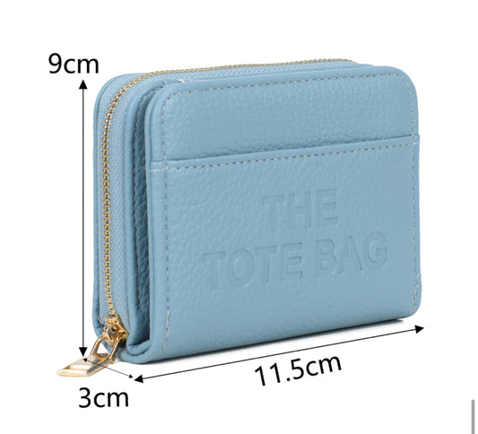 Blue wallet purse  with 'The Tote Bag' and a gold detail zip 