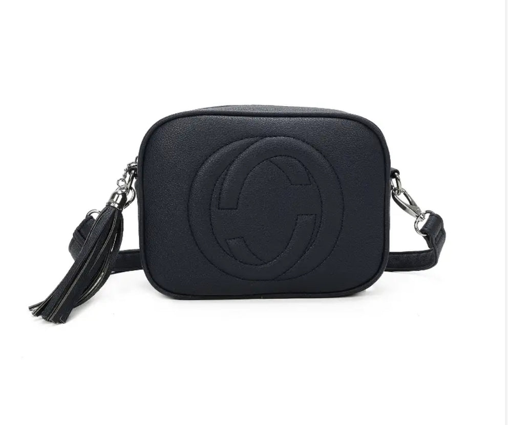 A navy crossbody camera bag with embossed circle logo design, detachable strap and tassel zip detail