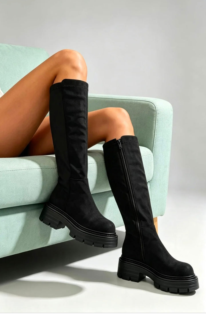 Black knee high stretch calf boots styled on model