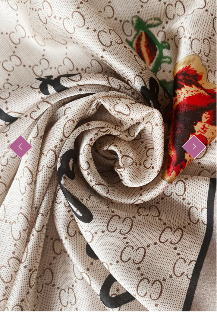 A beige scarf with a geometric pattern and a multicoloured floral emblem.