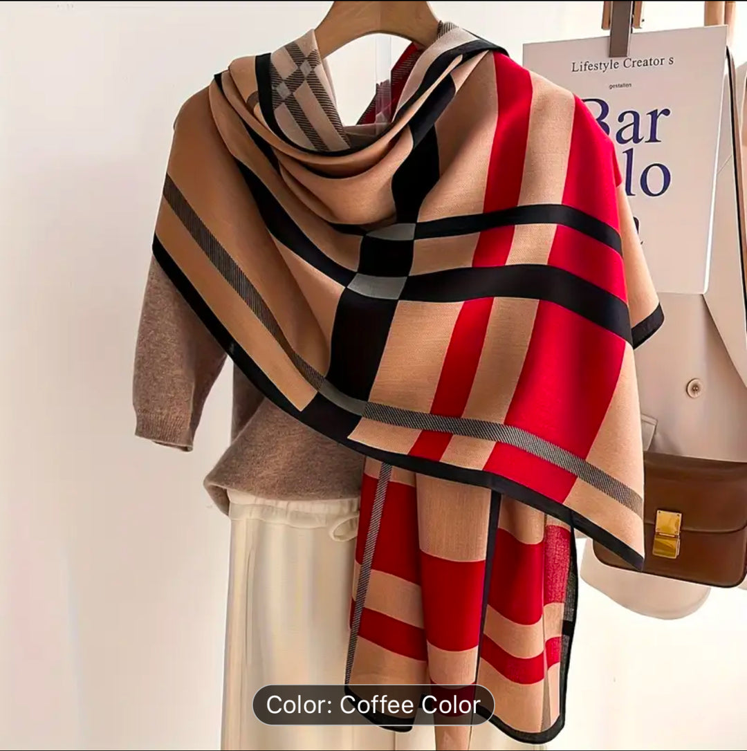 A beige scarf with red and black checked striped detail 