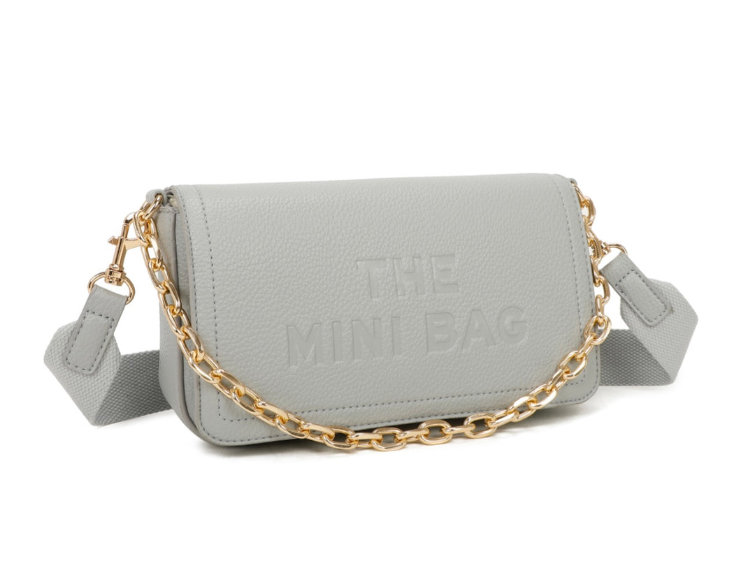 A grey mini tote bag with a chain detail and the text &