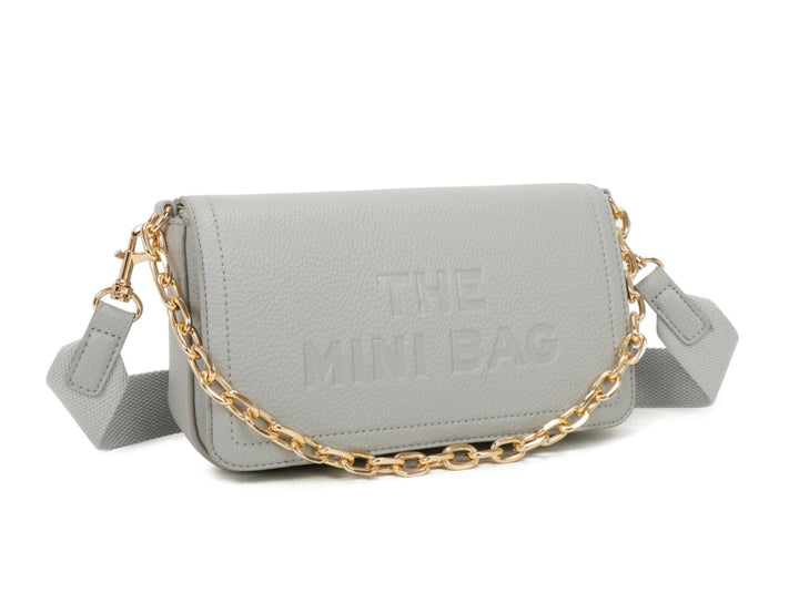A grey mini tote bag with a chain detail and the text &