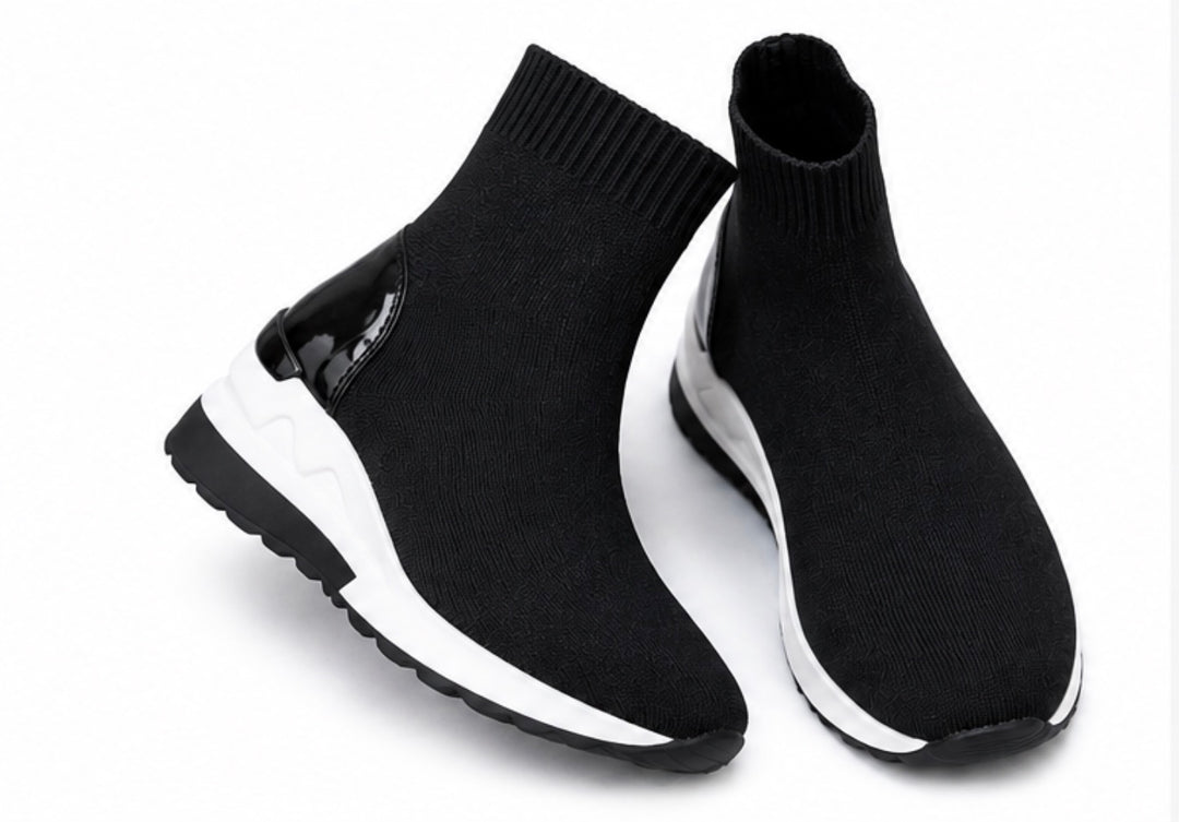 Black knit sock trainers with chunky white and black sole shown from multiple angles on a white background.