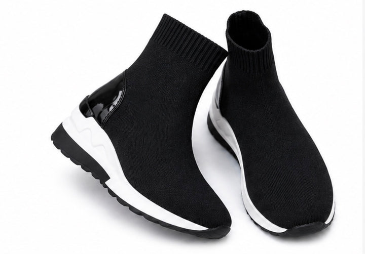 Black knit sock trainers with chunky white and black sole shown from multiple angles on a white background.
