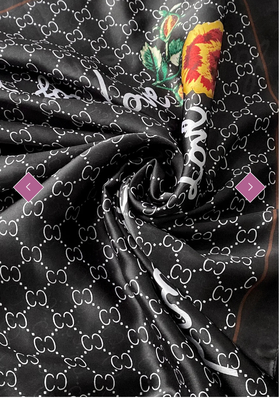 A black scarf with a geometric pattern and a multicoloured floral emblem.