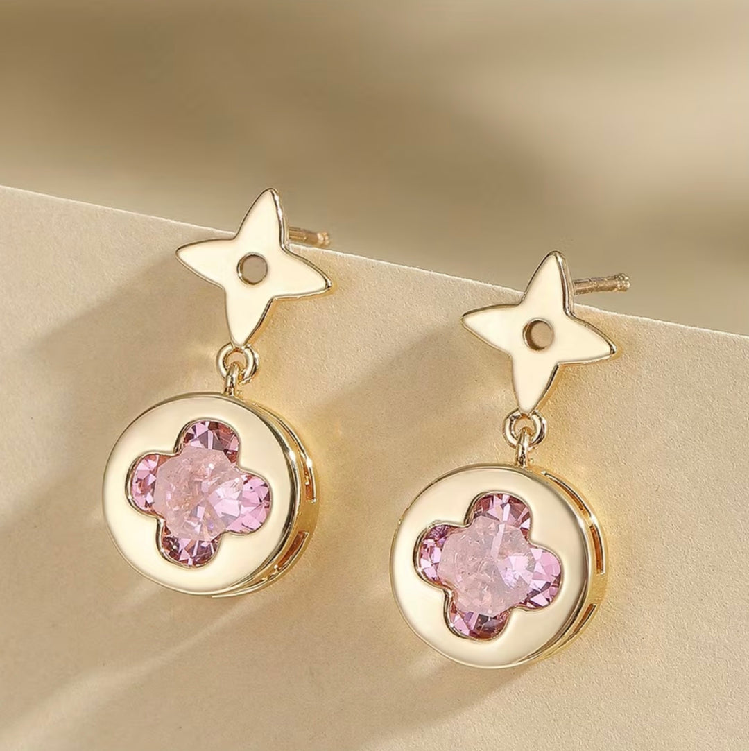     Gold clover drop earrings with pink crystal centre