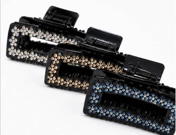 Black rectangular hair claw clip with sparkling rhinestone detailing